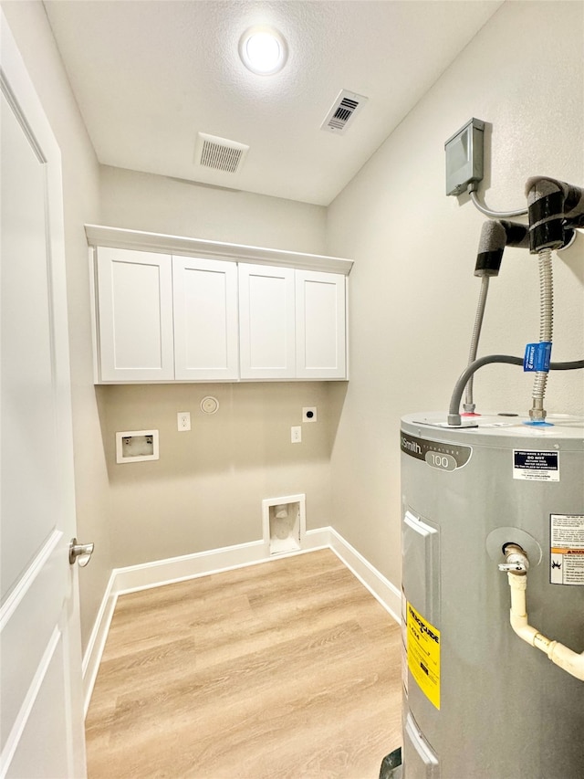 laundry room featuring hookup for an electric dryer, light hardwood / wood-style floors, washer hookup, cabinets, and water heater