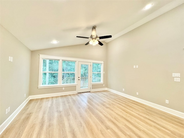 spare room featuring lofted ceiling, light hardwood / wood-style flooring, and ceiling fan