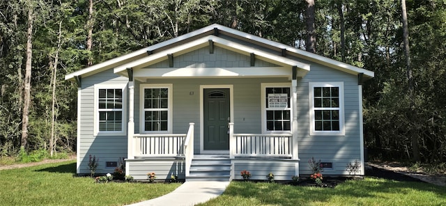 bungalow-style house with covered porch and a front yard