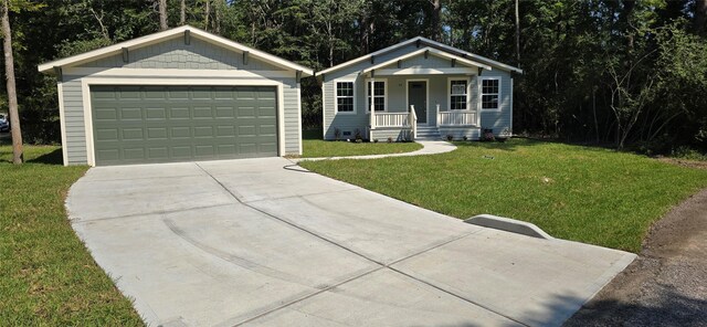 single story home with a garage, covered porch, a front lawn, and an outdoor structure