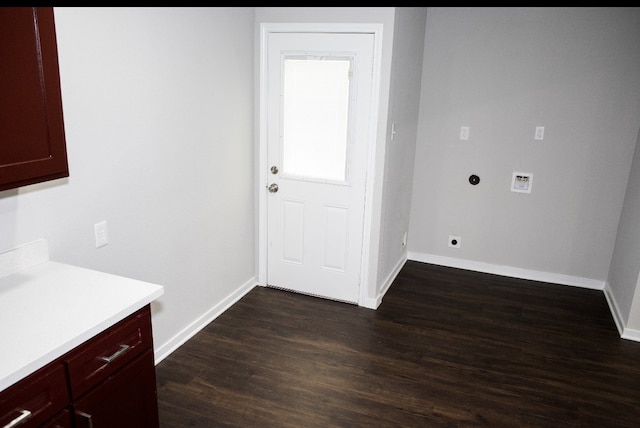 interior space featuring cabinets, hookup for an electric dryer, washer hookup, and dark hardwood / wood-style flooring