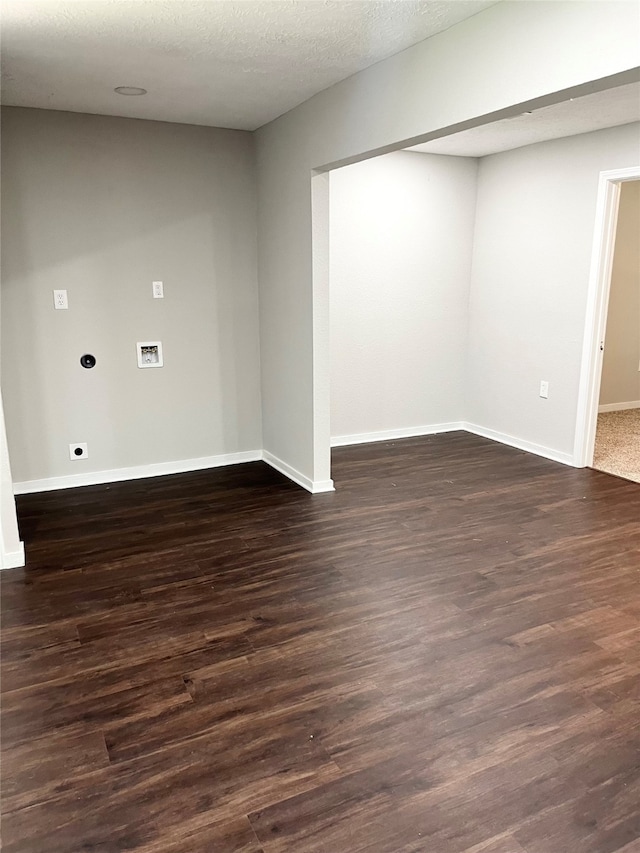 empty room featuring dark hardwood / wood-style flooring and a textured ceiling