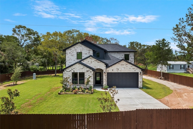 view of front of property featuring a garage and a front lawn