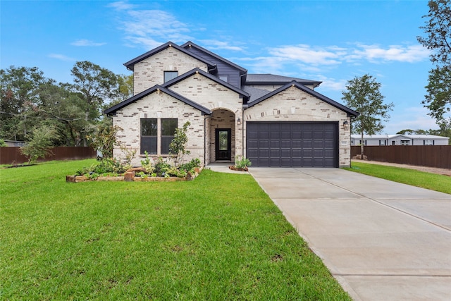 view of front of house featuring a garage and a front lawn