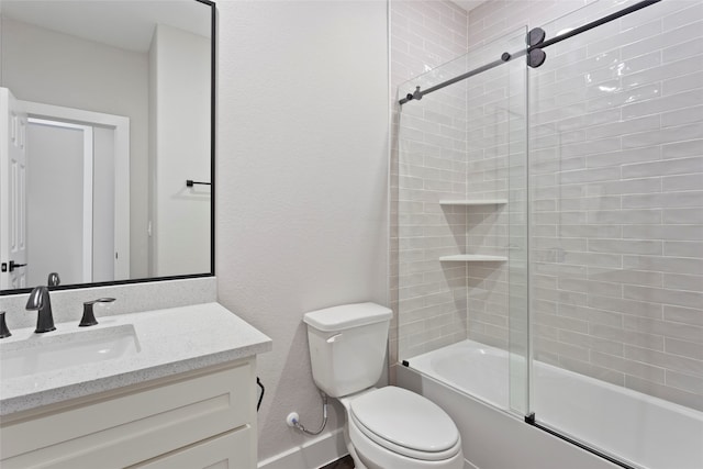 full bathroom with combined bath / shower with glass door, toilet, and vanity