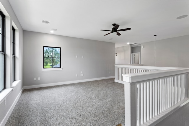 carpeted spare room with ceiling fan