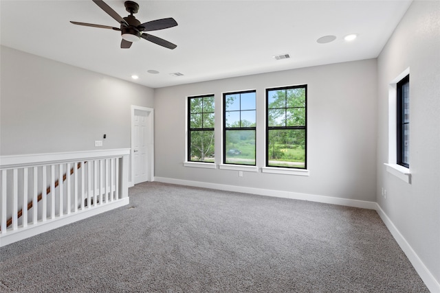 spare room featuring carpet and ceiling fan