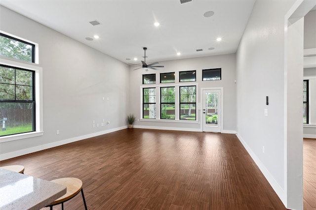 unfurnished living room with ceiling fan and hardwood / wood-style floors