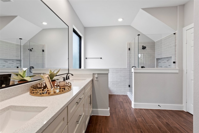 bathroom featuring an enclosed shower, wood-type flooring, and dual bowl vanity