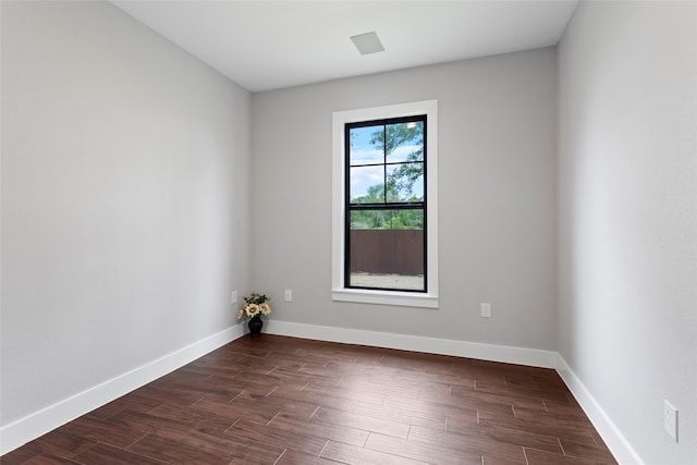 unfurnished room featuring dark hardwood / wood-style flooring