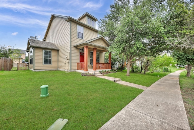 view of front facade featuring a porch, a front yard, and fence