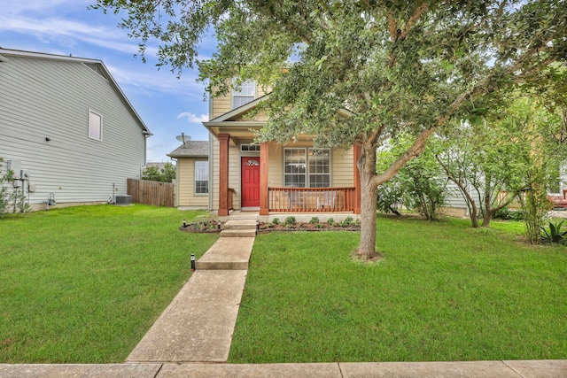 view of front facade with central air condition unit, fence, a porch, and a front yard