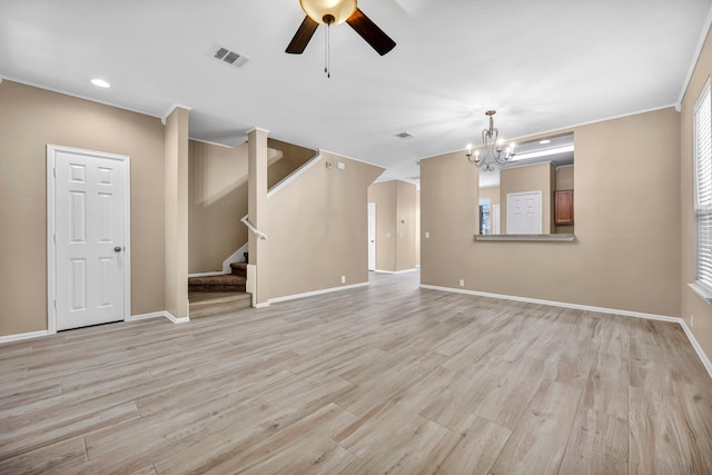 spare room with visible vents, baseboards, light wood-style flooring, stairs, and ceiling fan with notable chandelier