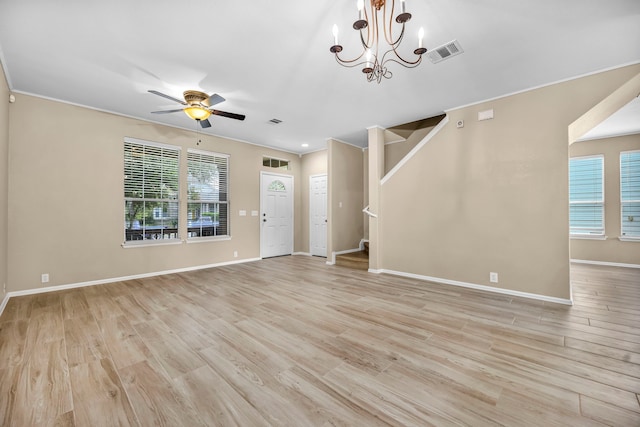 unfurnished living room featuring stairs, light wood-style flooring, visible vents, and a healthy amount of sunlight