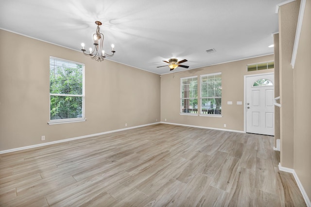 unfurnished room featuring light wood finished floors, visible vents, and baseboards