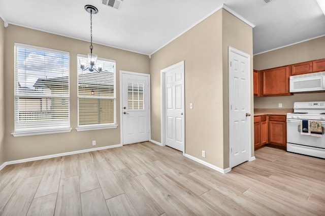 kitchen with decorative light fixtures, white appliances, ornamental molding, an inviting chandelier, and light hardwood / wood-style floors