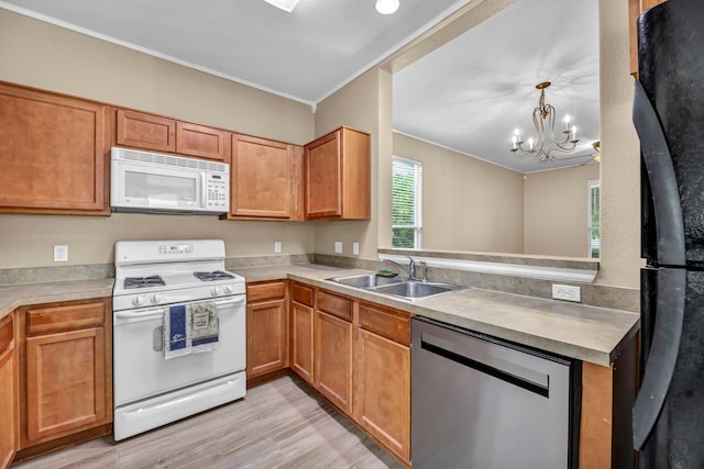 kitchen featuring brown cabinetry, white appliances, light countertops, and a sink