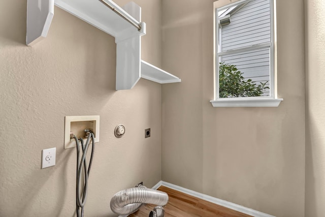 laundry area with electric dryer hookup, hookup for a washing machine, and hardwood / wood-style flooring