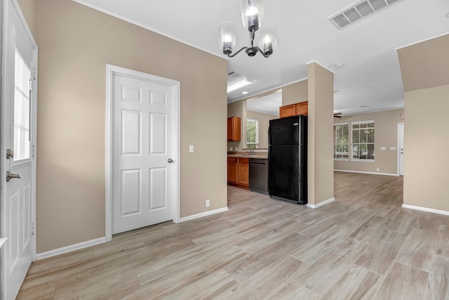 interior space featuring light wood-style floors, visible vents, a notable chandelier, and baseboards