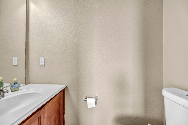 bathroom featuring toilet and vanity