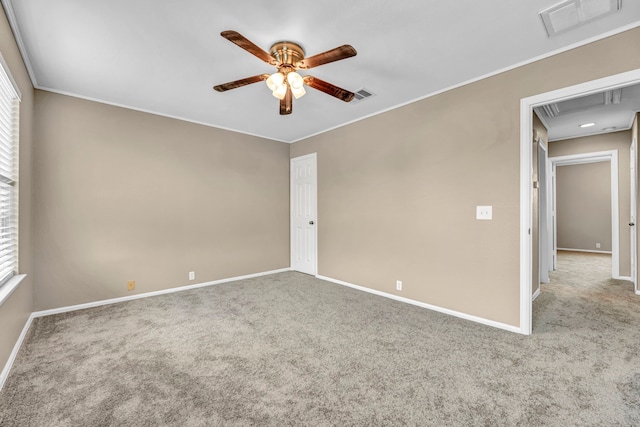 unfurnished room with light colored carpet, visible vents, and ceiling fan