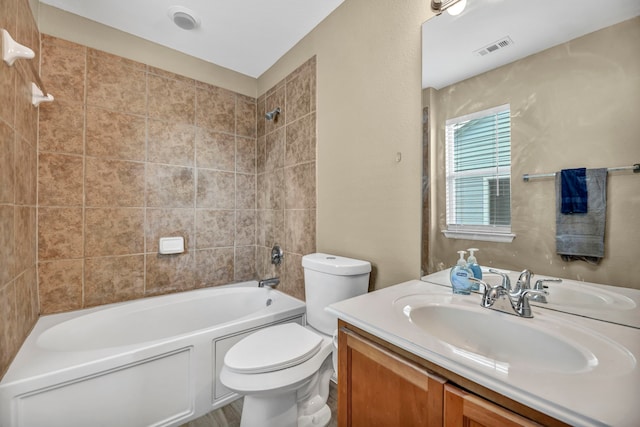 bathroom featuring shower / bath combination, visible vents, toilet, and vanity