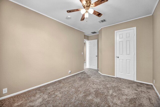 unfurnished bedroom featuring crown molding, carpet floors, and ceiling fan