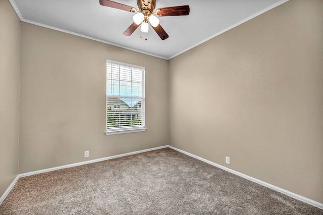 empty room with carpet floors, ceiling fan, baseboards, and crown molding