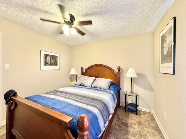 bedroom with a textured ceiling and ceiling fan