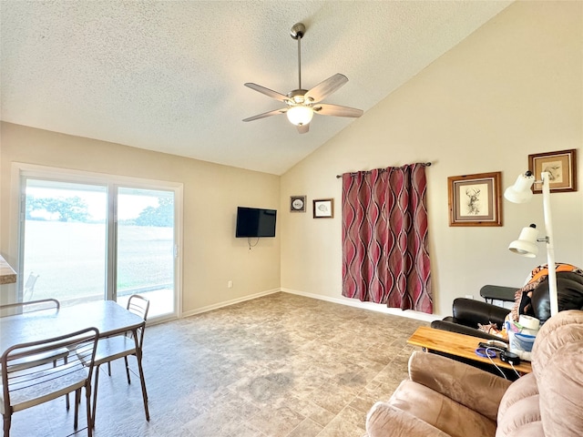 living room with a textured ceiling, high vaulted ceiling, and ceiling fan