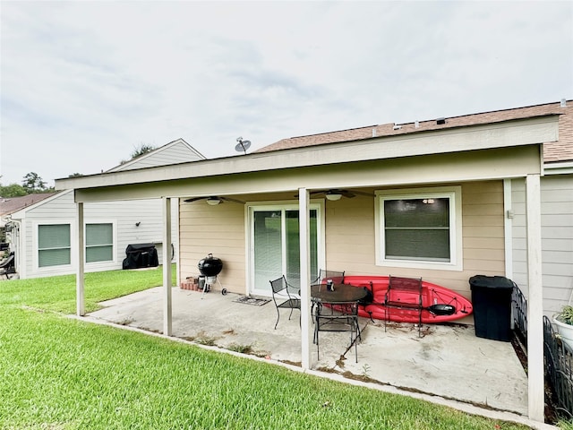 back of house with a patio area, a yard, and ceiling fan