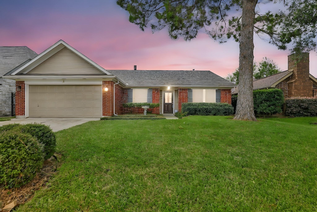 14103 Twisted Rattan Ln, Houston, TX 77015 - ranch-style house featuring a yard and a garage