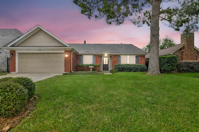 ranch-style house featuring a yard and a garage