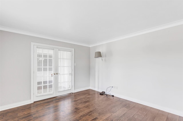 empty room with dark wood-type flooring, ornamental molding, and french doors