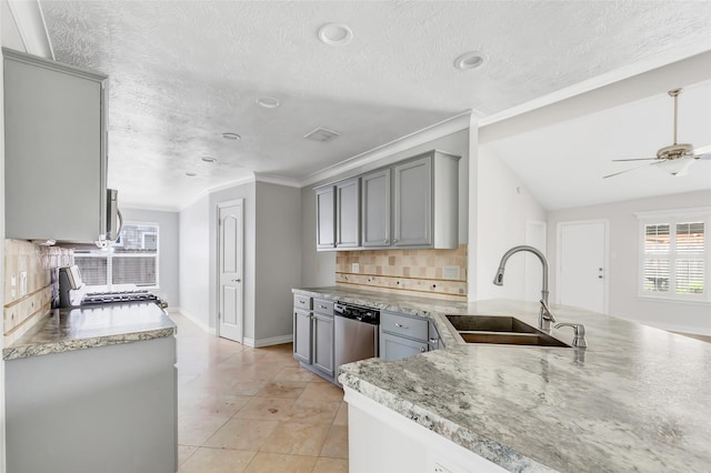 kitchen with gray cabinets, dishwasher, sink, and tasteful backsplash