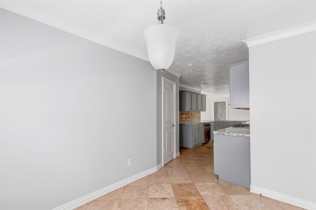 kitchen featuring decorative light fixtures, tasteful backsplash, sink, gray cabinetry, and crown molding