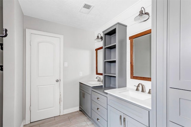 bathroom with vanity and a textured ceiling