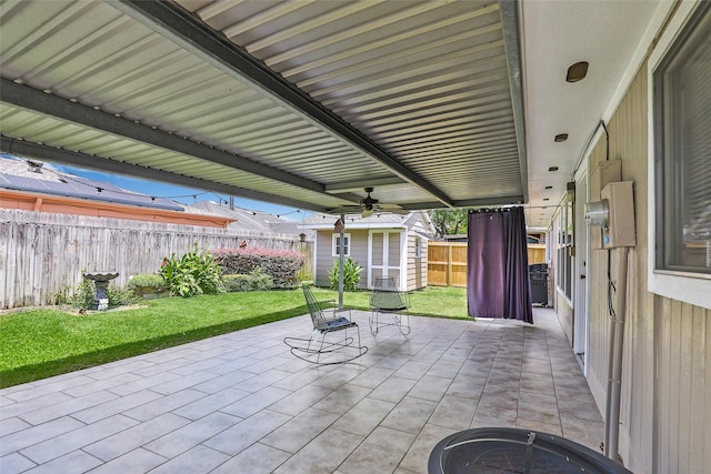 view of patio / terrace with a shed and ceiling fan