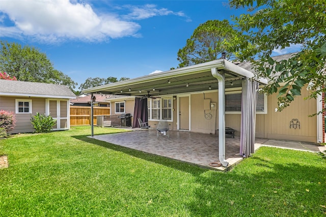 back of property featuring a patio area and a lawn