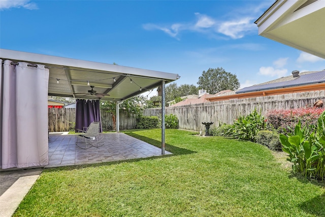 view of yard featuring a patio and ceiling fan