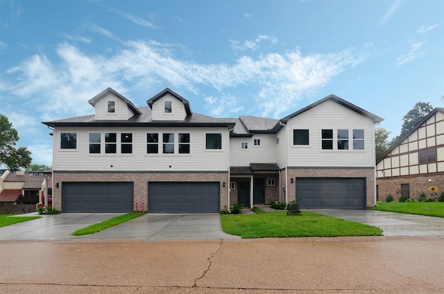 view of front of property with a front lawn and a garage