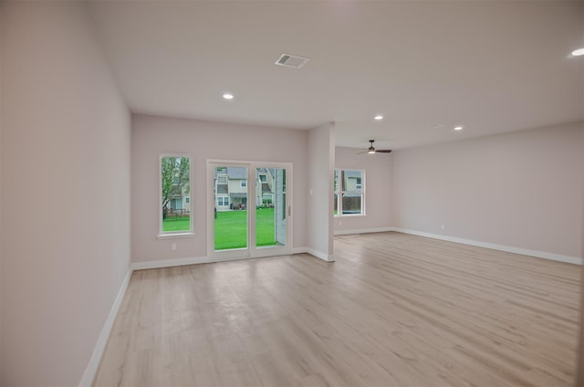 spare room with ceiling fan and light hardwood / wood-style flooring