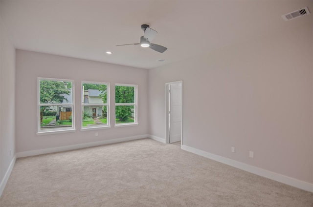 empty room featuring light carpet and ceiling fan