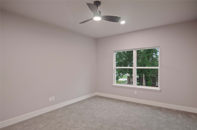 carpeted empty room featuring ceiling fan