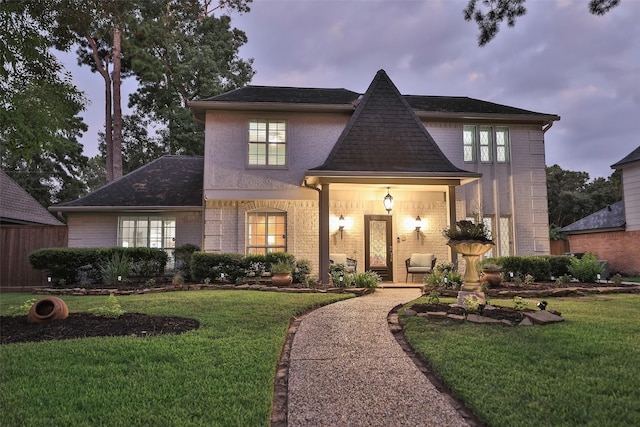 view of front of house with a yard and covered porch