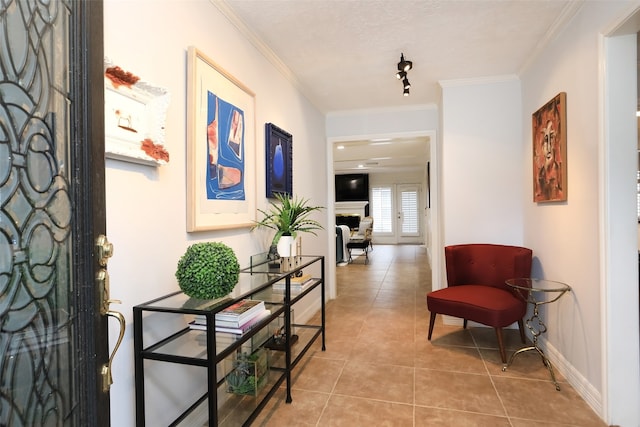 interior space featuring light tile patterned flooring and crown molding