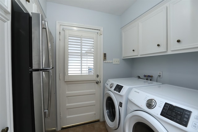 washroom with cabinets and washing machine and clothes dryer