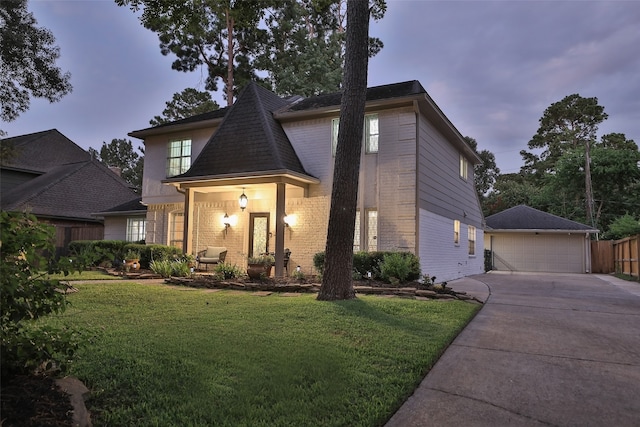 view of front of property with a garage and a lawn