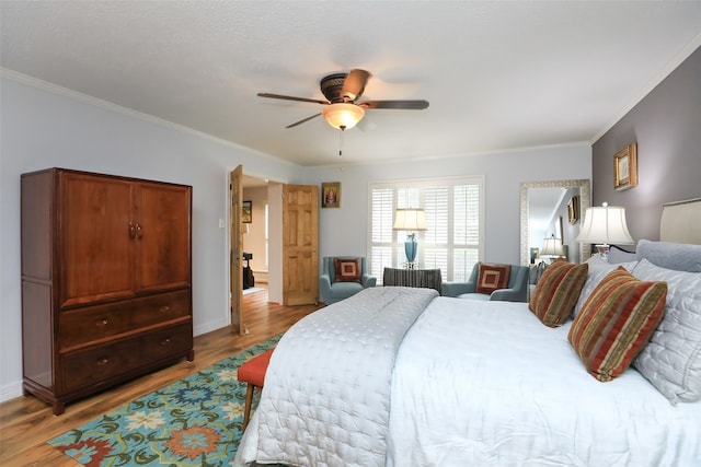 bedroom featuring crown molding, ceiling fan, and light wood-type flooring