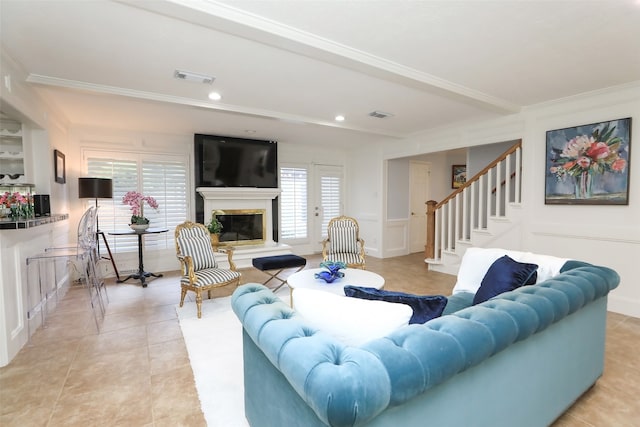 living room featuring light tile patterned floors and crown molding